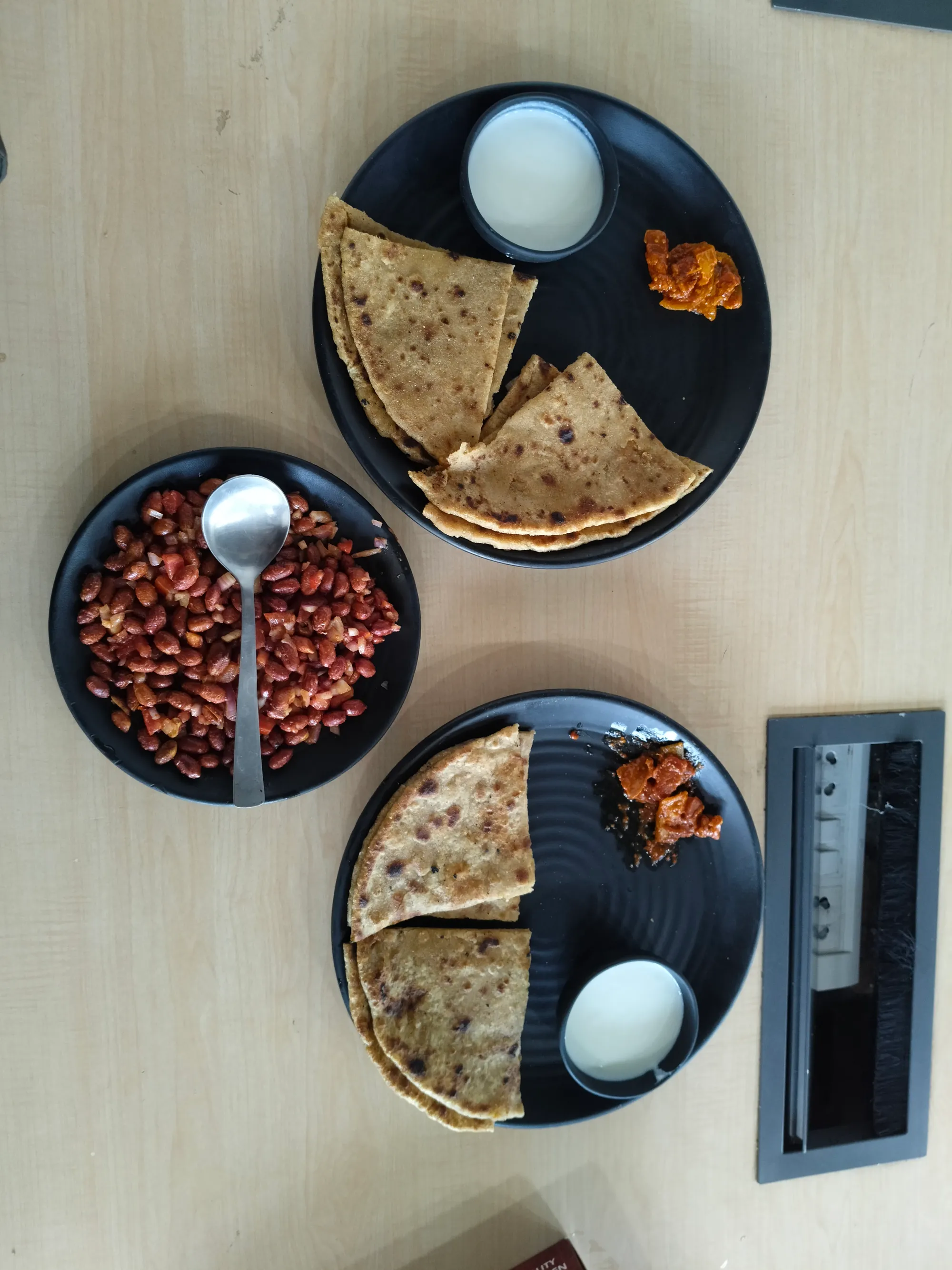 Homestyle Indian meal on black plates